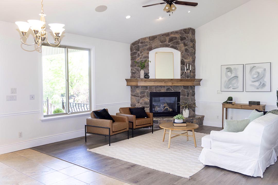 Common room with a stone fireplace and seating at Traverse Recovery Center in Bluffdale